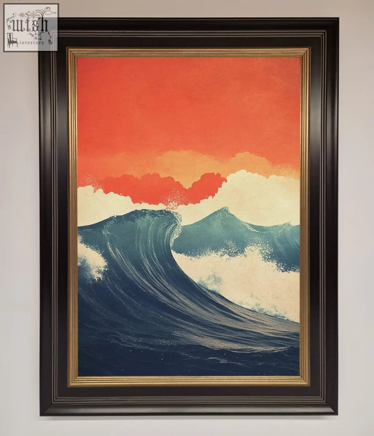 A framed poster showing blue waves crash under a red sunset sky in a dark brown frame with gold trim