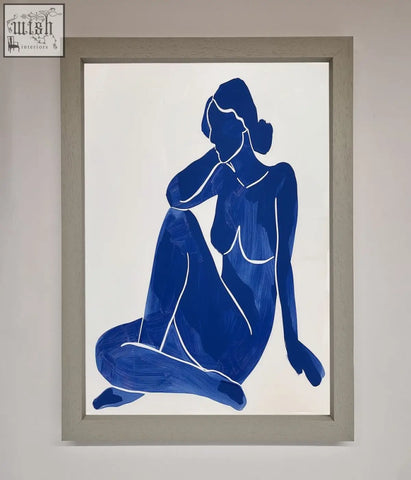 Blue woman pose framed print featuring a minimalist blue silhouette of a seated figure in light gray wood frame