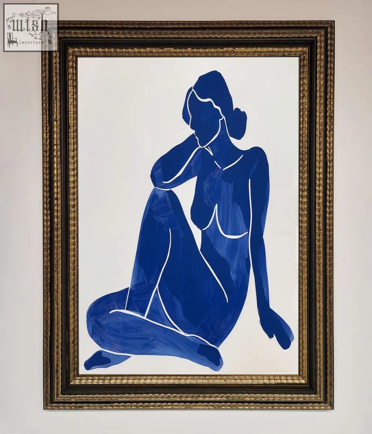 Blue woman pose framed print featuring a blue silhouette painting of a seated woman in gold frame in matisse style