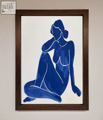 Blue silhouette painting of a seated woman in a dark wood frame showing a blue woman pose matisse style print