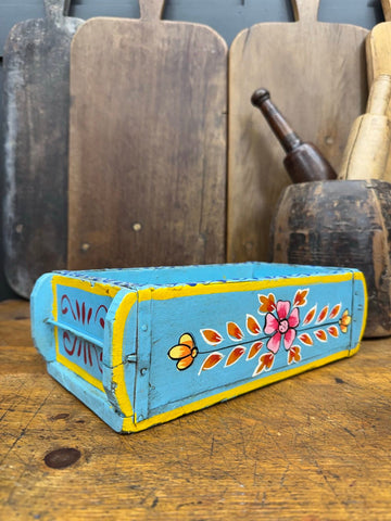 Hand-painted blue wooden brick mould with turquoise exterior yellow trim and colorful floral motifs for herbs or storage