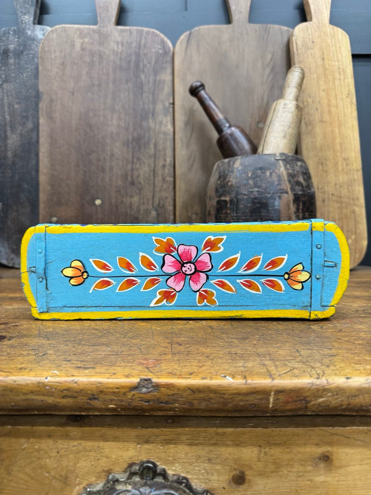 Hand painted wooden blue brick mould with turquoise body yellow trim and floral designs used as herb planter or tray