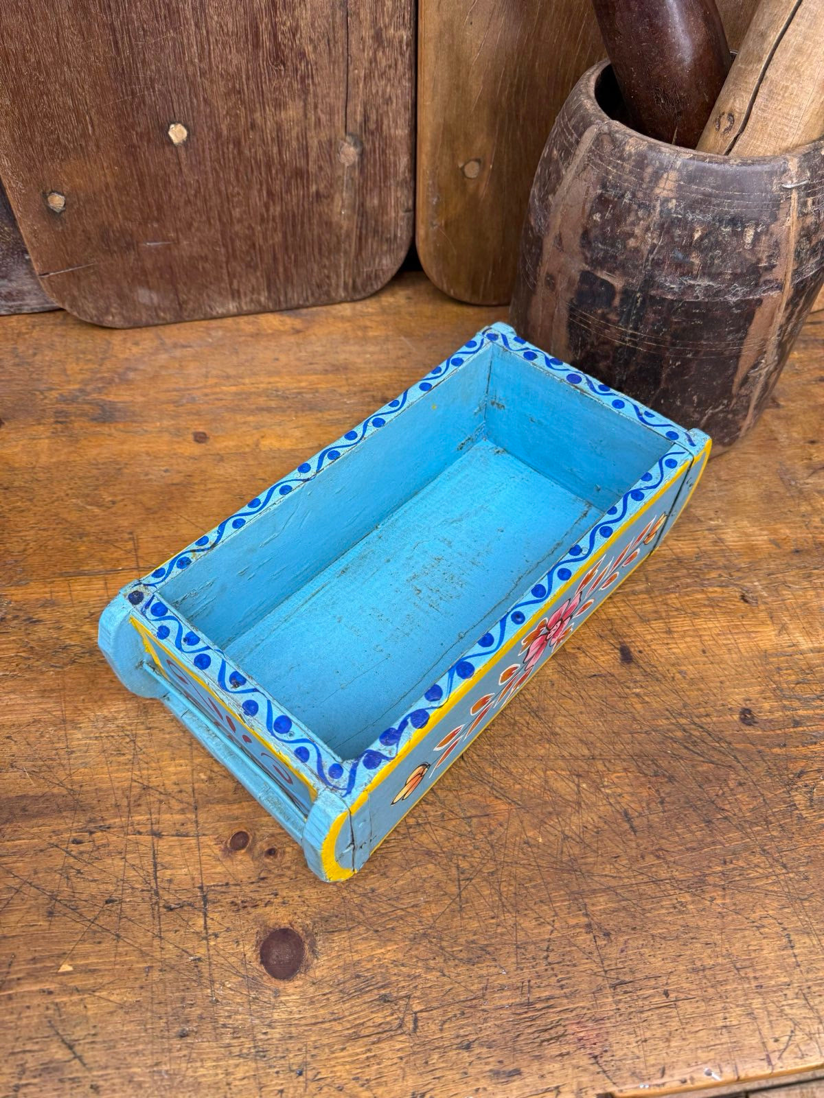 Hand-painted blue wooden storage box with colorful red yellow and navy floral patterns for herb planter or tray