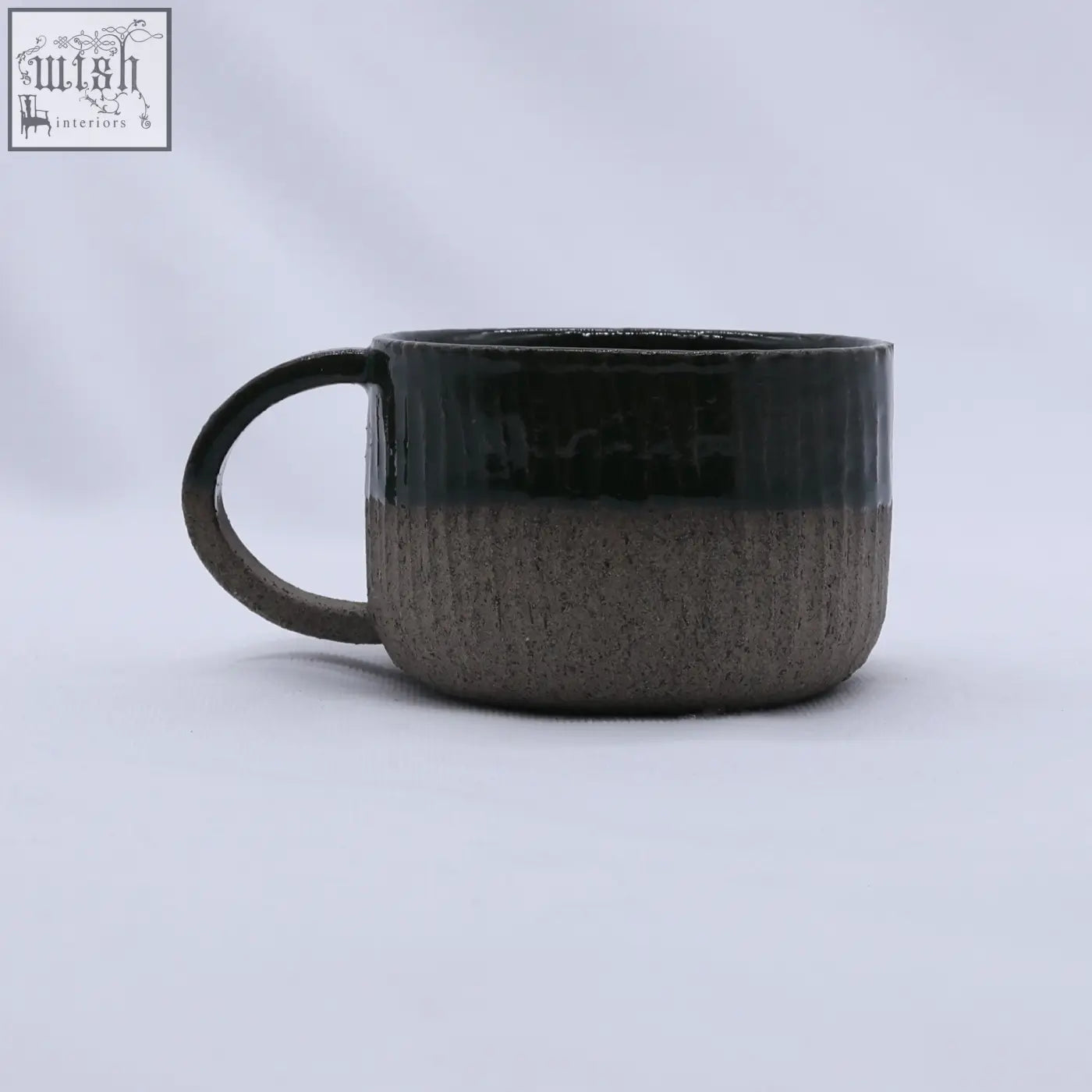 A bluverde arte handmade ceramic smoked grey stoneware mug with glossy black top and textured matte gray bottom