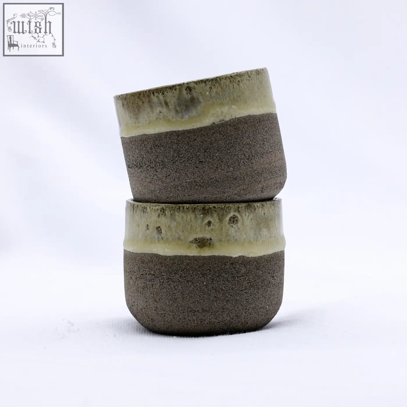 Two stacked bluverde picollo grey handmade ceramic stoneware espresso mugs with earthy brown body and green glazed rims