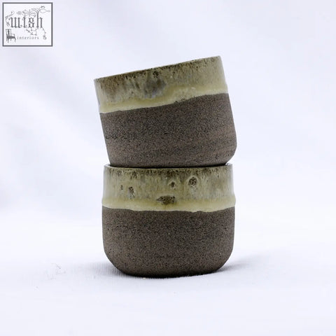 Two stacked bluverde picollo grey handmade ceramic stoneware espresso mugs with earthy brown body and green glazed rims