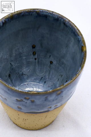 A handcrafted bluvio quadra stoneware ceramic mug with deep blue and speckled beige glaze and gold rim accents