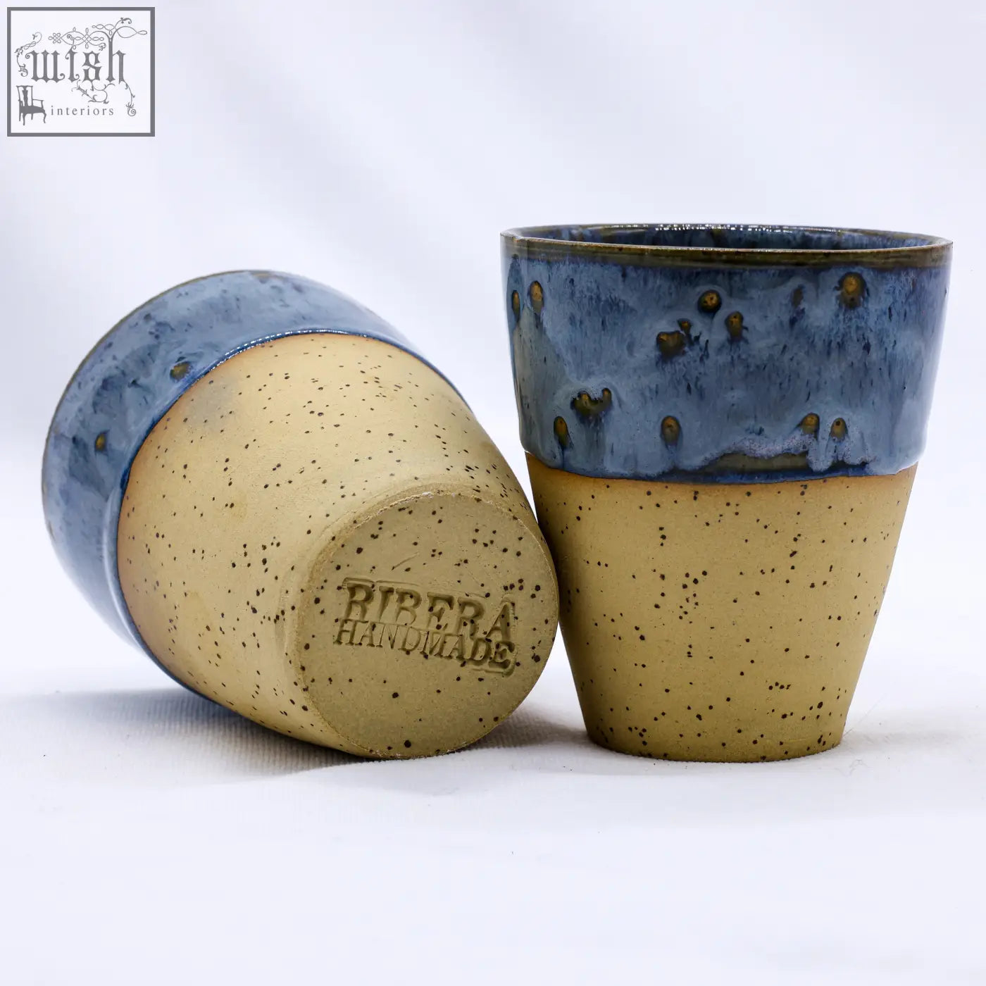 Handcrafted bluvio quadra stoneware ceramic mug with a speckled beige body blue glazed rim and golden dots