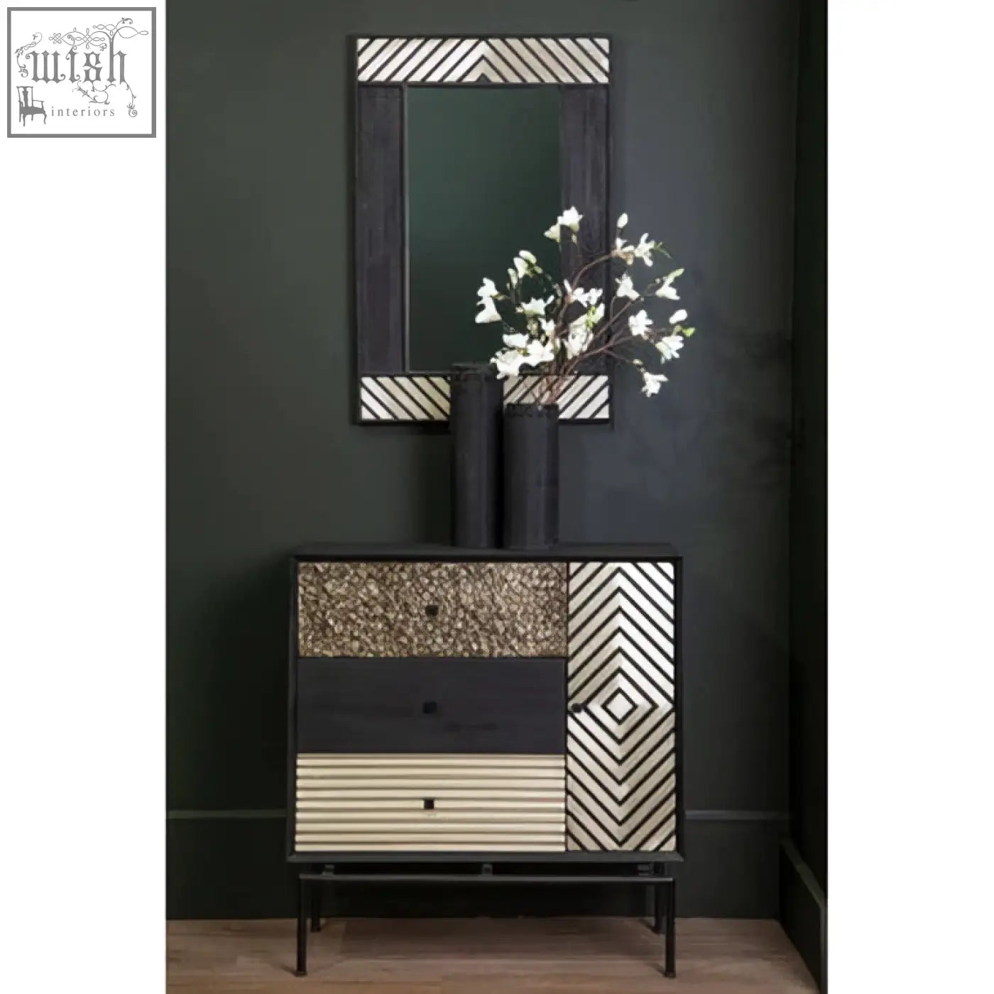 Boho black wall mirror shown above a black and cream geometric-patterned console table with textured drawer fronts