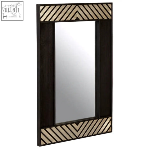 Boho black wall mirror with a dark wood frame and decorative chevron-patterned mirrored panels on black wall