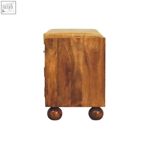 A warm-toned wooden bola shoe storage bench side table with smooth polished finish and rounded ball feet