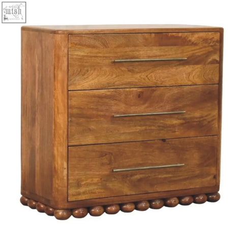 Warm-toned wooden bola three drawer chest with sleek metallic handles and rounded bead detailing at the base