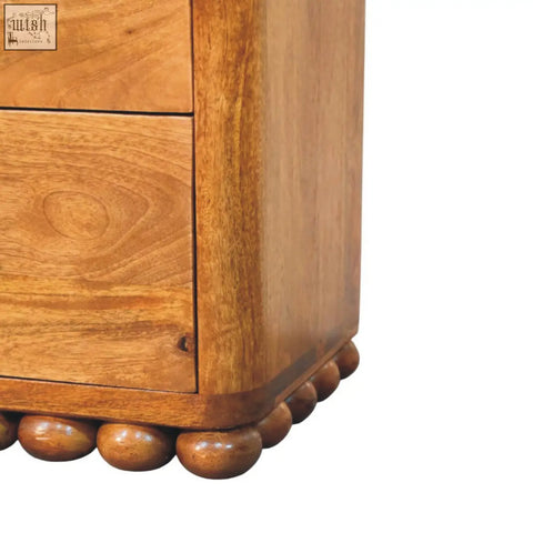Warm-toned wooden bola three drawer chest with smooth polished finish and decorative rounded ball feet