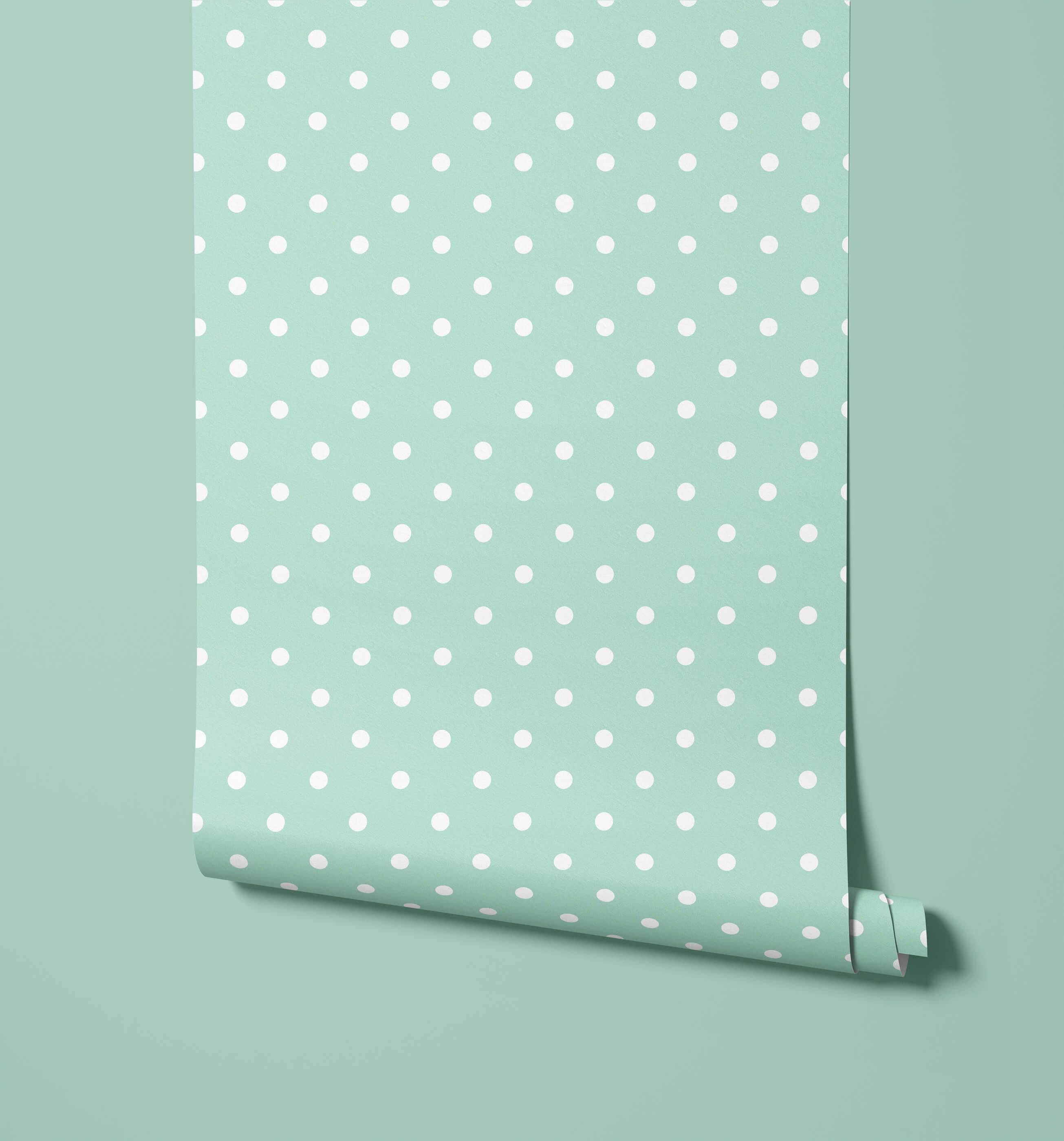 A roll of bonbon mint green polka dot wallpaper with white evenly spaced dots perfect for stylish walls