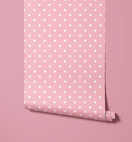 Pink bonbon polka dot wallpaper with white dots and a rolled bottom edge for fun dot wallpaper decor