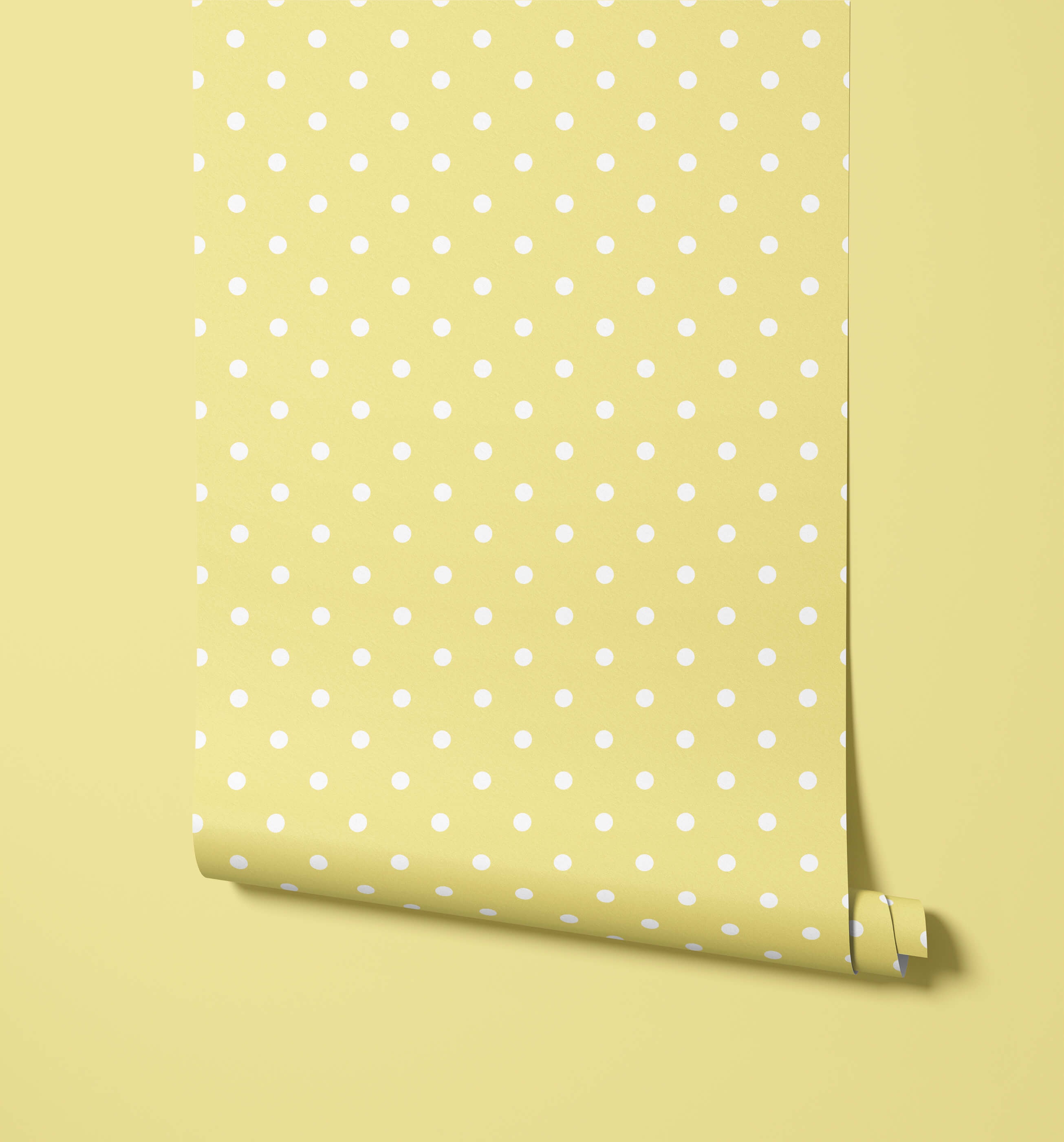 A roll of bonbon pale yellow polka dot wallpaper with evenly spaced white dots perfect for fun dot wallpaper designs