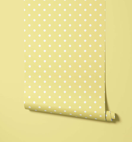 A roll of bonbon pale yellow polka dot wallpaper with evenly spaced white dots perfect for fun dot wallpaper designs