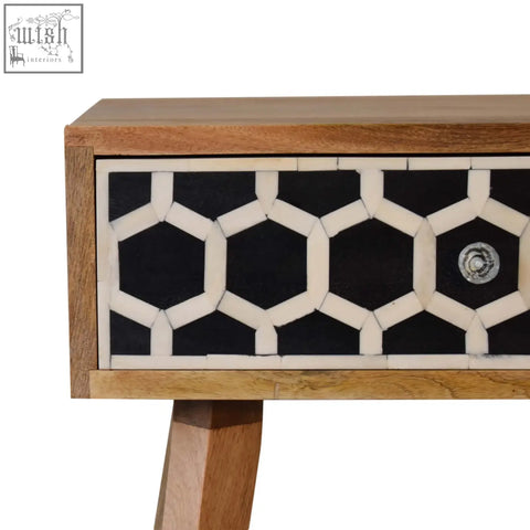 Black and white bone inlay drawer front on a solid mango wood tapered bedside table with oak-ish finish
