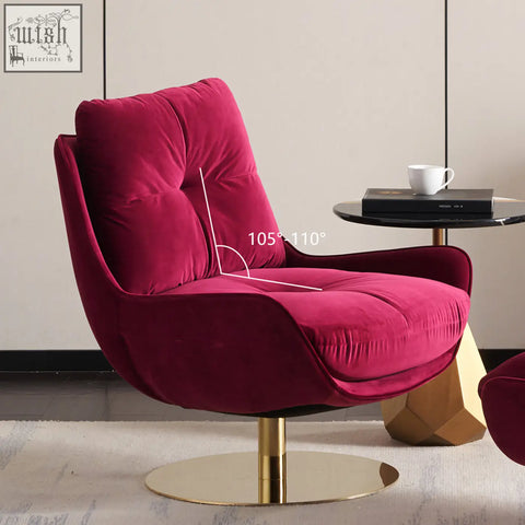 A deep magenta velvet bonnet swivel lounge chair with tufted back and gold-toned pedestal base