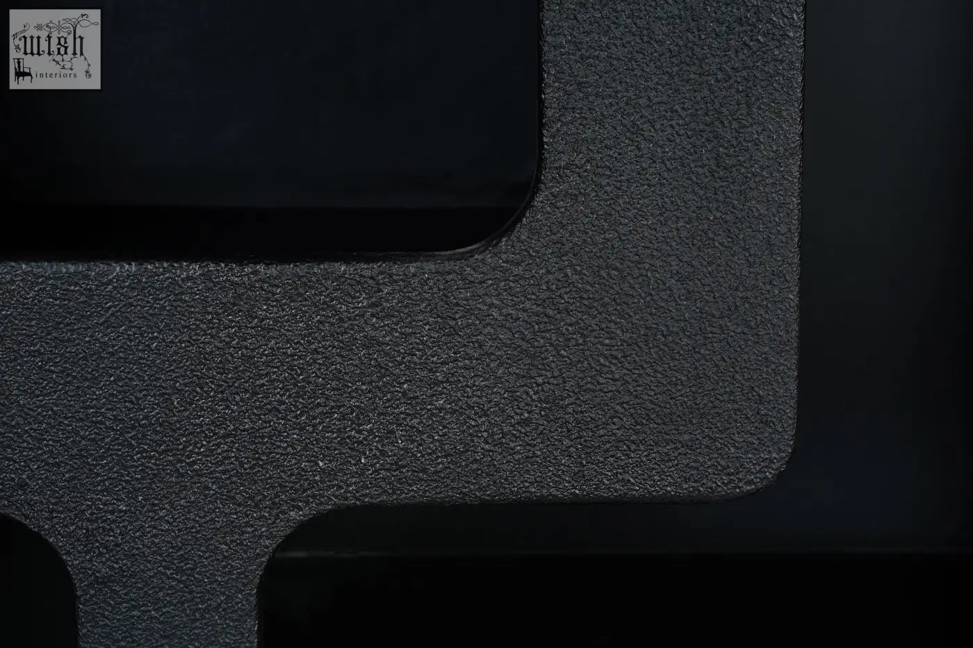 Black textured surface with matte black finish on otis tall geometric tall geometric bookcase made of faux leather material