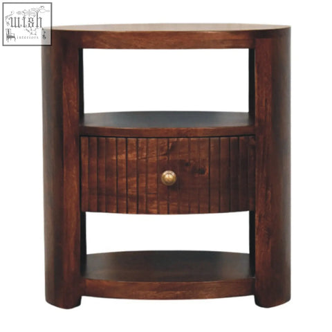 Dark brown bordeaux bedside table made of natural mango wood with curved frame and slatted drawer with brass knob