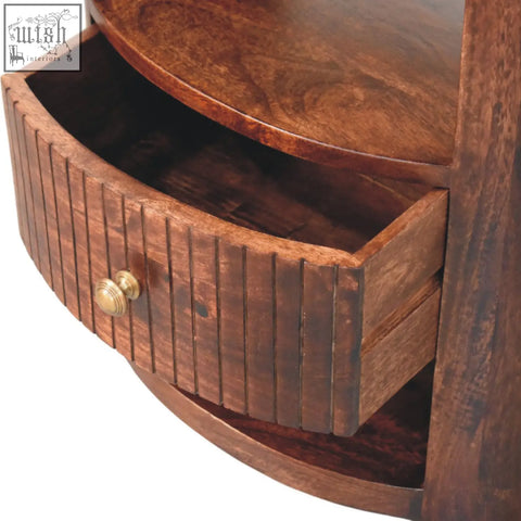 Rich brown bordeaux bedside table made of natural mango wood with curved drawer and brass knob for bedroom use