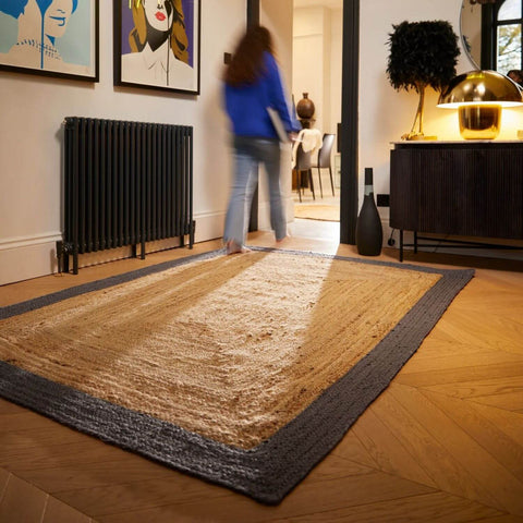Rectangular bordered grey jute rug with natural beige woven center and dark gray textured handcrafted border