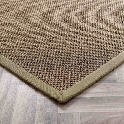 Natural fiber bordered sage green sisal rug with textured woven surface in earthy beige and olive green tones