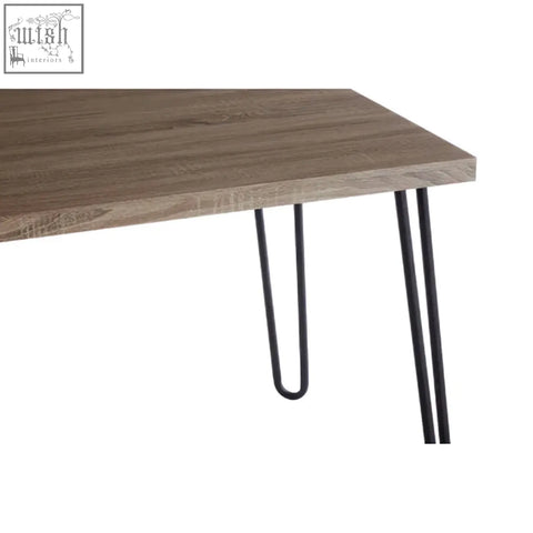 Modern dining table with a gray wood effect veneer top and black finish metal hairpin legs for stylish dining spaces