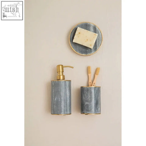 Gray metallic soap dispenser with gold-tone pump paired with bosco grey marble tumbler for stylish bathroom use