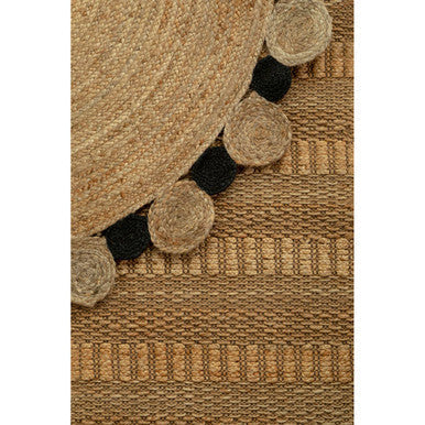 Beige woven large natural jute rug with black jute pom-pom trim perfect for cozy living spaces