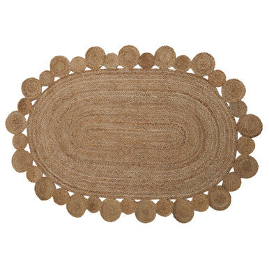 Natural fiber bosie demir ova jute rug with a textured woven surface and scalloped edge with circular tufts
