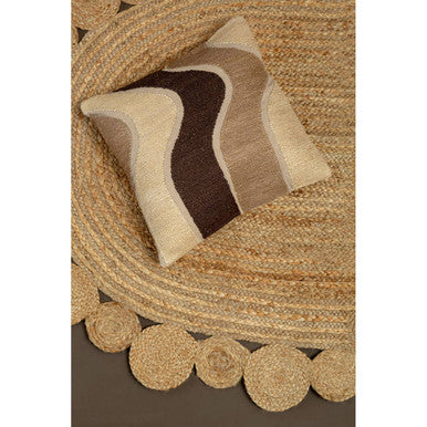 A square cushion with a wavy beige and brown abstract pattern paired with bosie demir ova jute rug