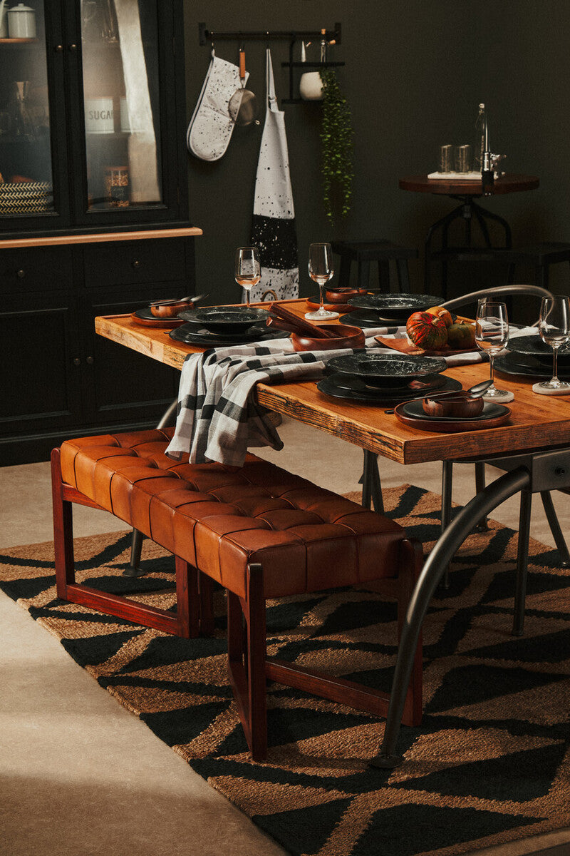 Brown tufted leather dining bench with wooden legs shown on a bosie hemp large rug for stylish dining spaces
