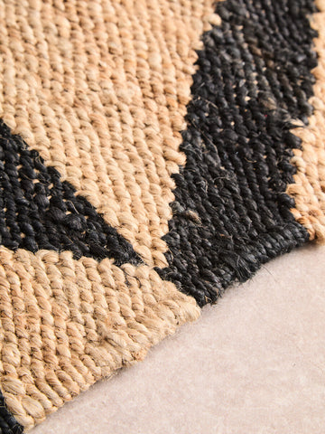 Handwoven bosie hemp large rug with bold black and beige zigzag pattern made from natural fiber hemp large rug