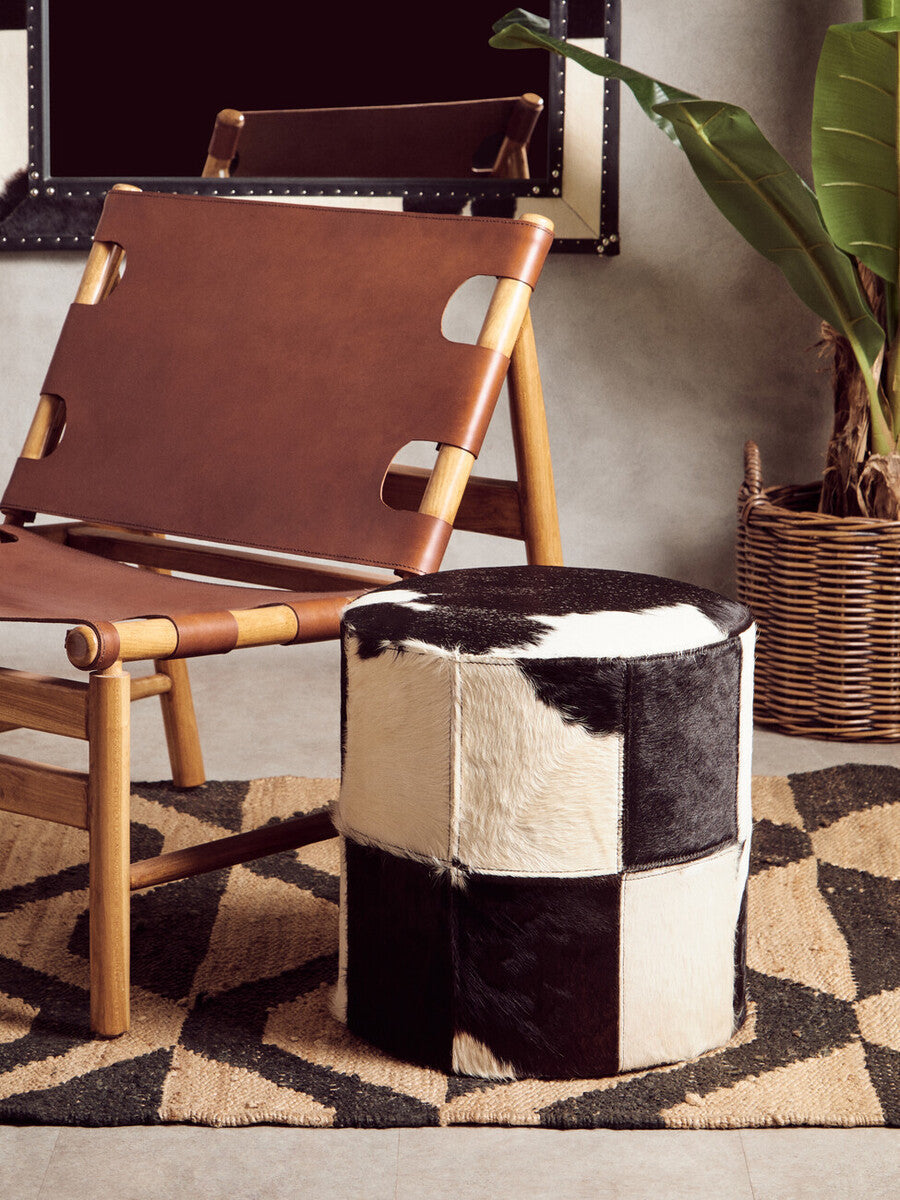 Black and white cowhide patchwork ottoman paired with bosie hemp small rug showing natural hemp small texture