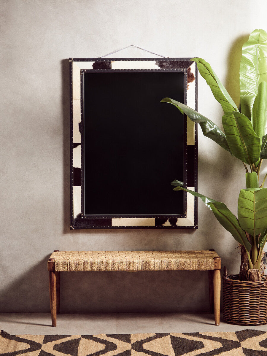 Rectangular mirror with black studded frame and mirrored panels shown on bosie hemp small rug