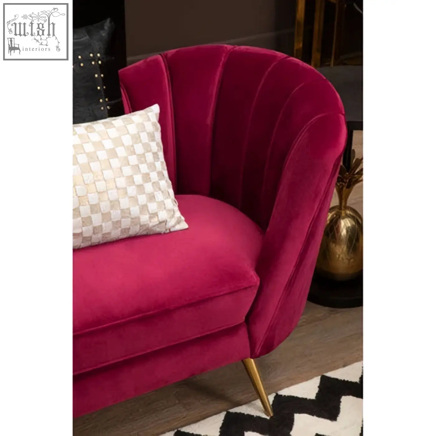 A plush fuchsia velvet armchair with gold-tone legs paired with a bosie kensington townhouse cream gold cushion