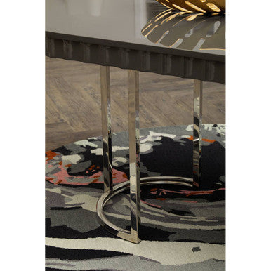 Chrome finished metal table legs with curved base under stylish bosie moyo round rug with sleek modern design