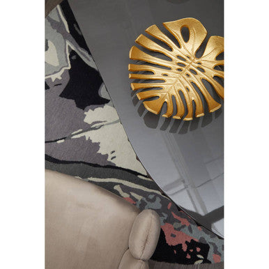 Golden monstera leaf shaped decorative tray styled on a bosie moyo round rug for chic home decor