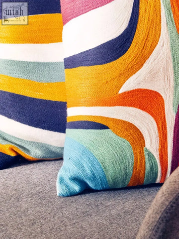 Bosie ozella abstract design cushion with vibrant orange blue yellow and white flowing stripes design cushion