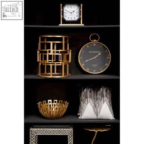 Gold geometric lantern with modern lattice design and black accents next to bosie ozella black white embroidered cushion