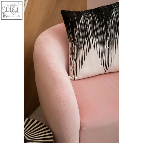 A soft pink velvet bosie ozella black and white embroidered cushion with a bold fringe design for stylish decor