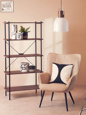Beige upholstered armchair with black legs and bosie ozella black and white semi circular design cushion