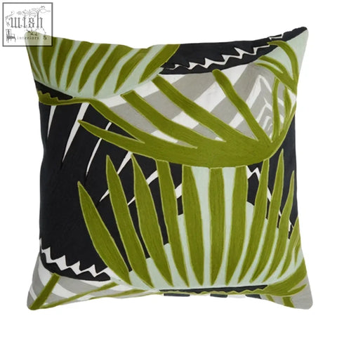 Bosie ozella botanical green cushion featuring a bold green botanical green palm frond design on black and gray background