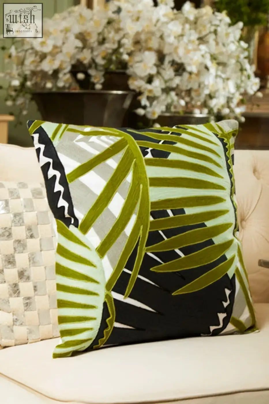 Bosie ozella botanical green cushion with vibrant green and black palm leaf pattern on light sofa as a green cushion