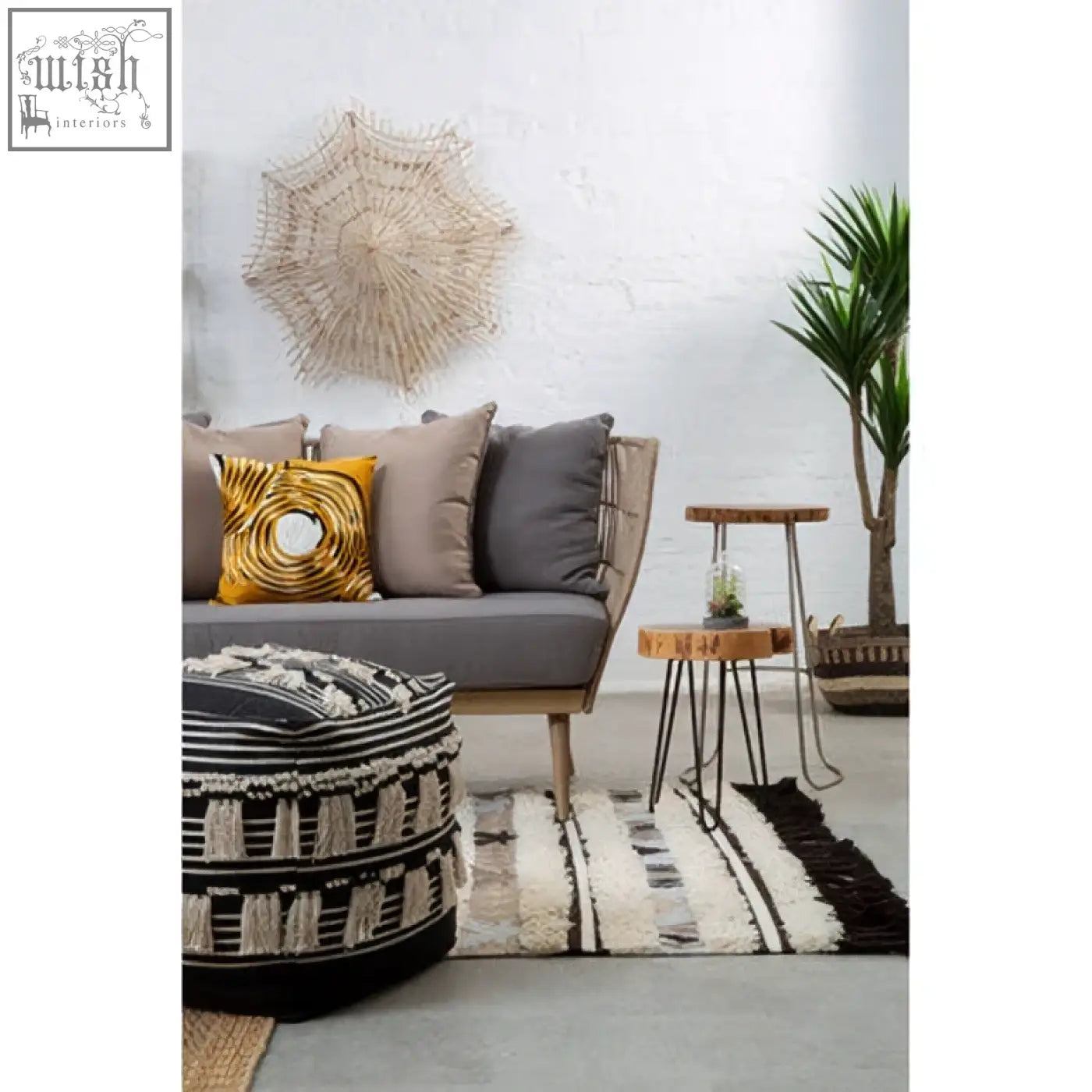 Black and white striped pouf with tassel trim featuring bosie ozella circular design embroidered cushion style