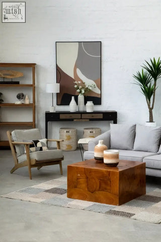 Bosie ozella circular rectangular cushion with circular print embroidered design on rustic amber wooden coffee table