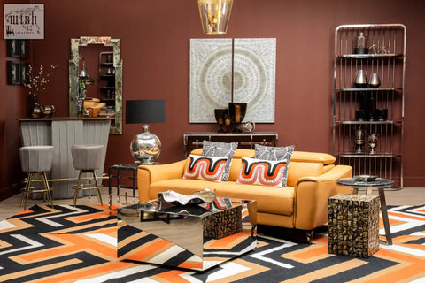 Vibrant orange leather sofa with bold black and white ozella curve pattern rectangular cushion pillows