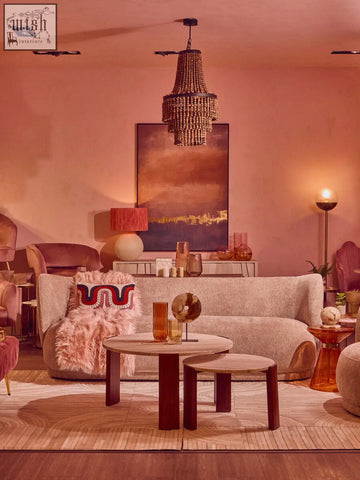 A warm-toned wood bead chandelier with dark metal frame complements the ozella curve pattern rectangular cushion